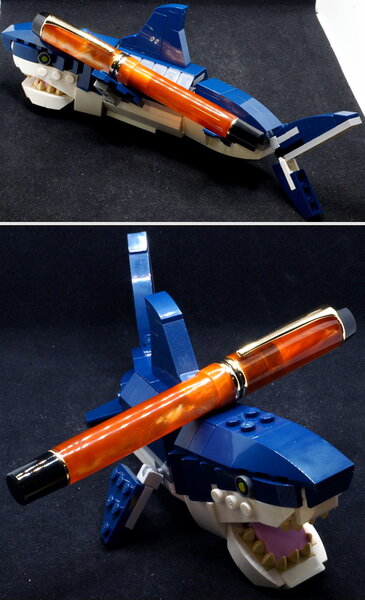 Swirly orange Kaigelu 316 pen propped up by Lego shark (2 pics)