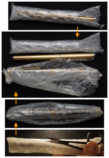 Removing two pens from their cocoons of bubble wrap and packing tape